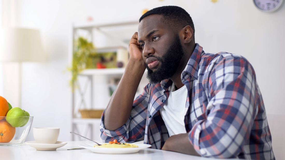 a-man-not-eating-a-bowl-of-food-in-front-of-him-because-he-has-a-loss-of-appetite-due-to-anxiety