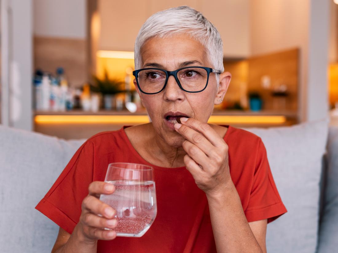 a-woman-taking-appetite-stimulants-with-water