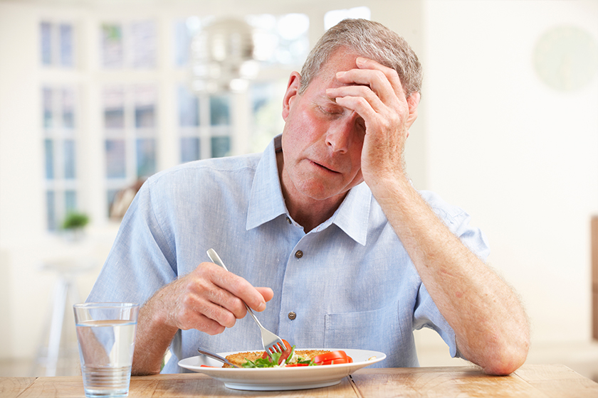 sick-older-man-trying-to-eat